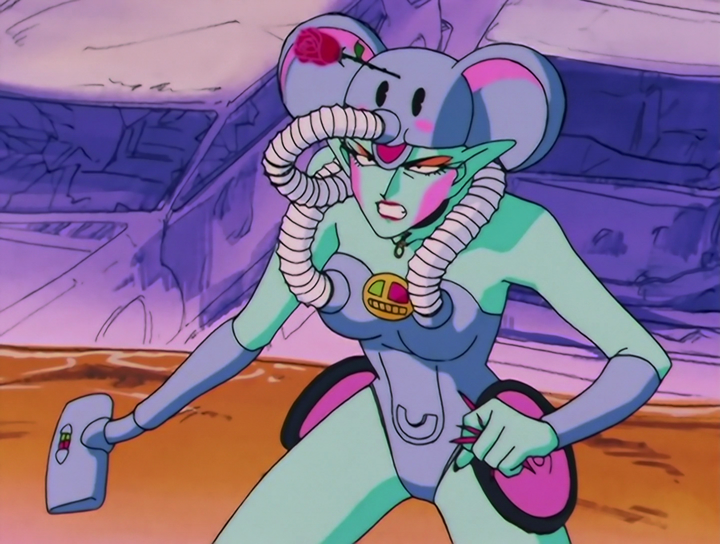 Osouji, a Daimon from Sailor Moon episode 94. She has turquoise skin, as do half the monsters on this list, apparently. She also has orange eye shadow and pink makeup that’s oddly only on the sides of her face. So, she was made from a novelty elephant vacuum cleaner, and that is everywhere in her design. Her helmet is the cheerful elephant head, with the hose-trunk going back over her shoulder. Her outfit looks like molded plastic and incorporates two additional hoses, one over each boob, which also go back over her shoulders. There’s also what’s likely a power indicator or switch on her chest, and two pink wheels on her hips. One arm is transformed into a vacuum cleaner’s pipe and brush. I feel like there should be a better name for those parts, but multiple diagrams are assuring me that’s what they’re called. She also has a rose sticking out of her helmet. New data acquired: Tuxedo Mask’s roses are sharp enough to embed themselves in plastic.